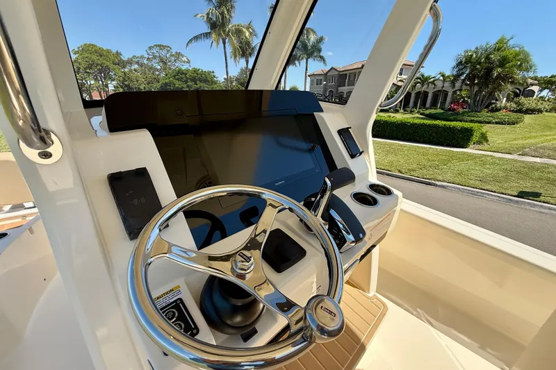 Slide: The Image of 2025 Scout 261 XSS boat helm with steering wheel and control panel. - 22
