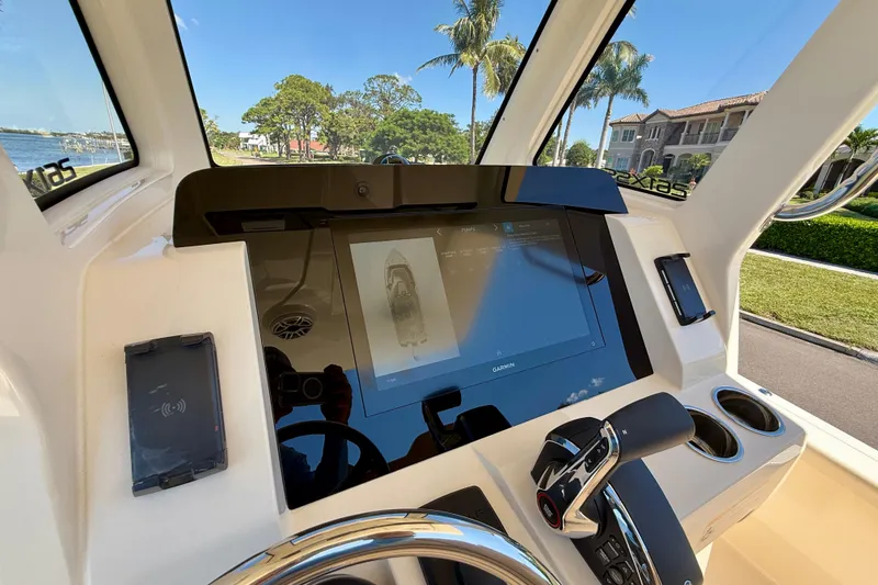 Slide: The Image of 2025 Scout 261 XSS boat dashboard with touchscreen display and control panel. - 25