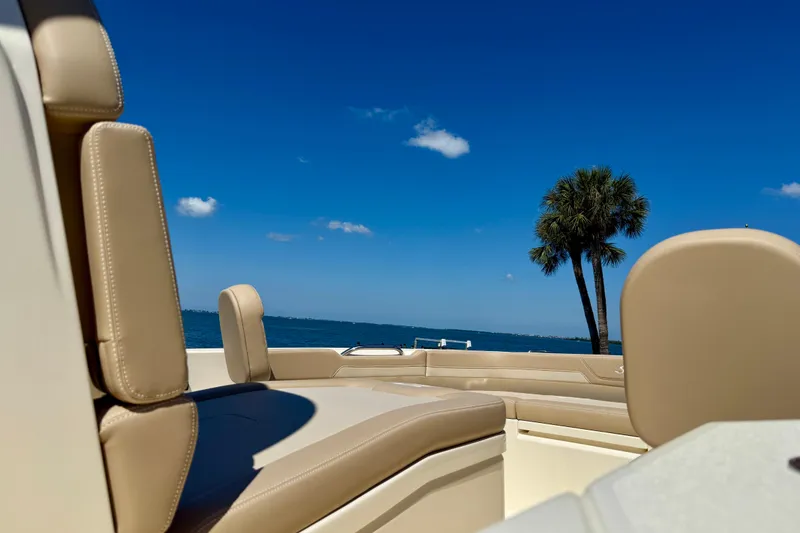 Slide: The Image of 2025 Scout 261 XSS boat interior with ocean view and palm tree. - 33
