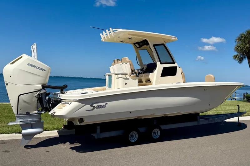 Slide: The Image of 2025 Scout 261 XSS boat with Mercury engine on trailer by waterfront. - 6
