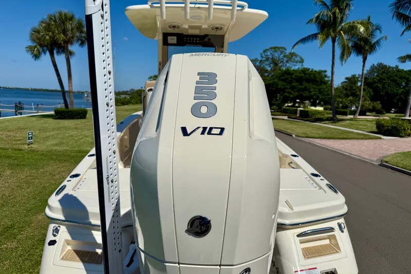 Slide: The Image of 2025 Scout 261 XSS boat with Mercury 350 V10 engine, parked near waterfront. - 8