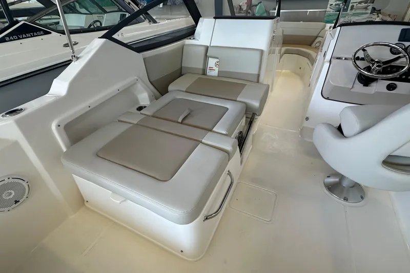 Slide: The Image of 2026 Boston Whaler 210 Vantage interior with cushioned seating and steering wheel. - 12