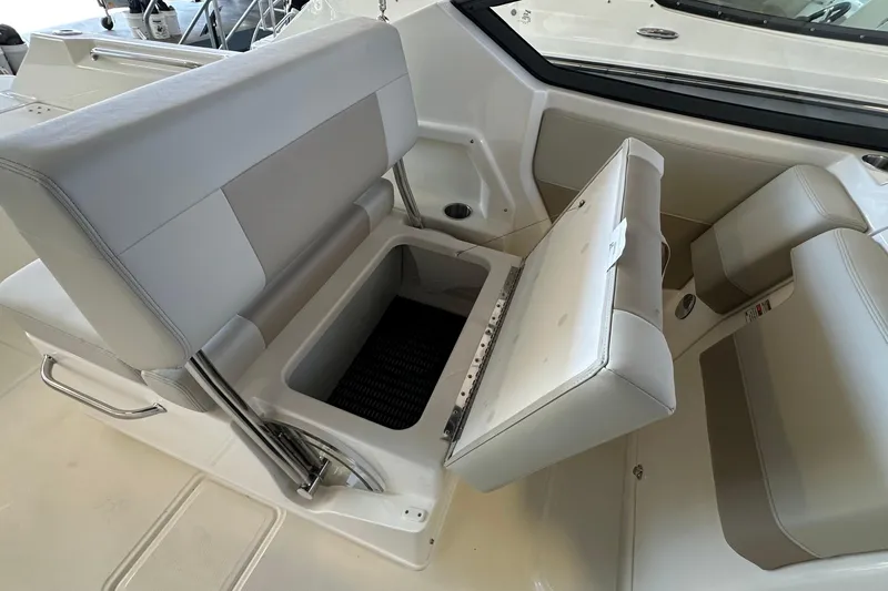 Slide: The Image of 2026 Boston Whaler 210 Vantage boat seat with storage compartment open. - 14