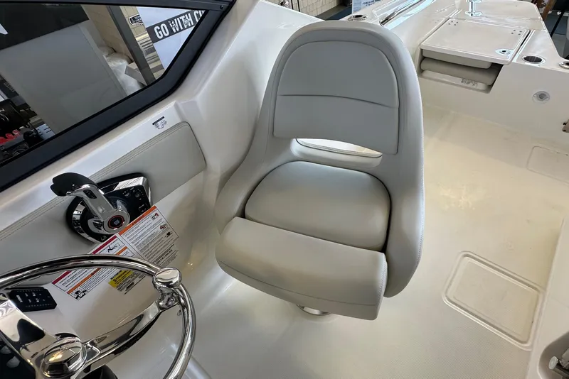 Slide: The Image of 2026 Boston Whaler 210 Vantage helm seat and steering wheel detail. - 19
