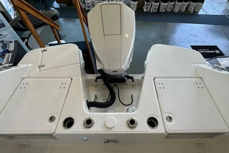 Slide: The Image of 2026 Boston Whaler 210 Vantage boat deck with engine and storage compartments. - 2