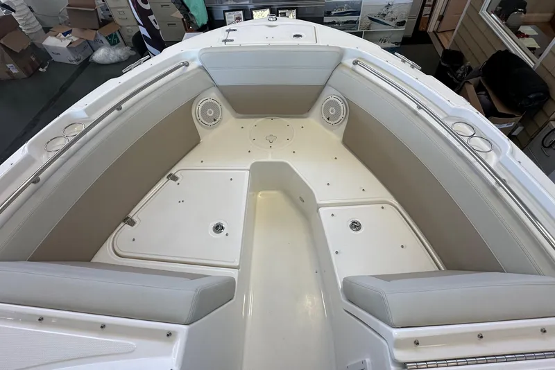 Slide: The Image of 2026 Boston Whaler 210 Vantage boat interior with cushioned seating and storage compartments. - 26