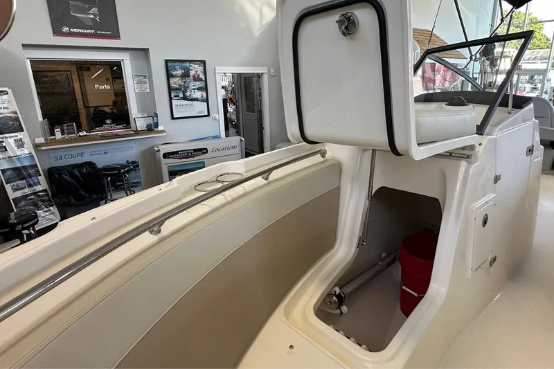 Slide: The Image of Boston Whaler 210 Vantage 2026 boat interior with storage compartment and seating. - 27