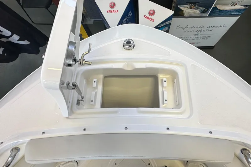 Slide: The Image of 2026 Boston Whaler 210 Vantage boat interior with storage compartment and Yamaha branding. - 29
