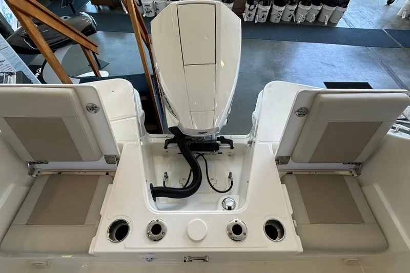 Slide: The Image of 2026 Boston Whaler 210 Vantage boat interior with seating and engine view. - 3