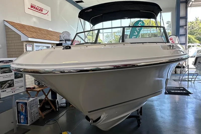 Slide: The Image of 2026 Boston Whaler 210 Vantage boat displayed in showroom, front view. - 30