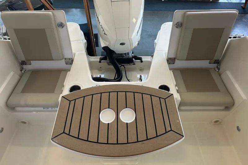 Slide: The Image of 2026 Boston Whaler 210 Vantage boat interior with seating and motor view. - 4