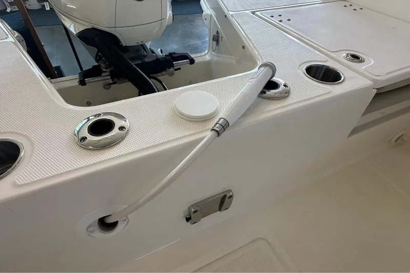 Slide: The Image of 2026 Boston Whaler 210 Vantage boat deck with hose and motor detail. - 6