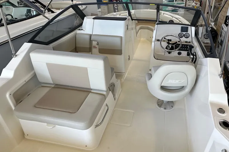 Slide: The Image of 2026 Boston Whaler 210 Vantage boat interior with seating and steering console. - 7