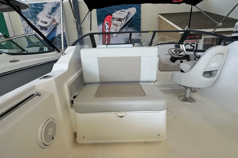 Slide: The Image of 2026 Boston Whaler 210 Vantage interior with seating and helm, showcasing modern design. - 8