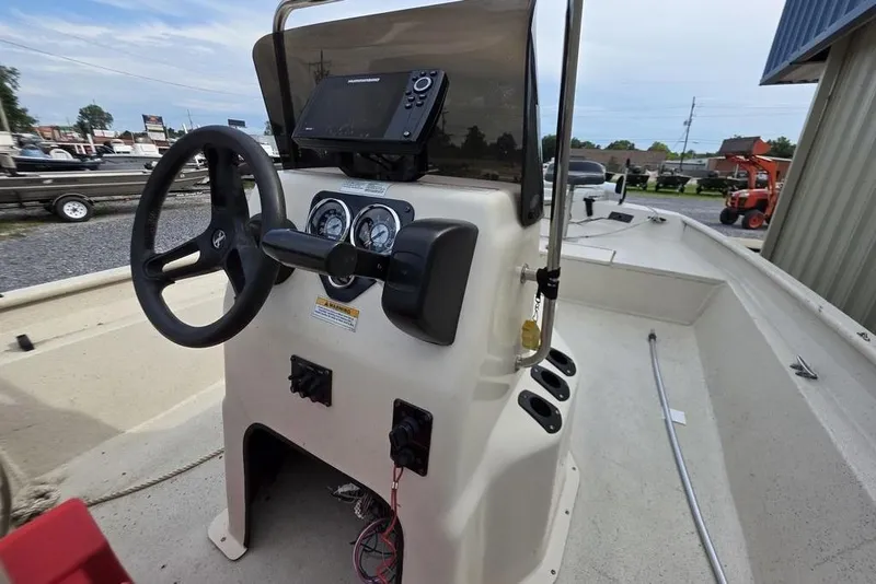 Slide: The Image of 2012 Xpress HD22CCF boat console with steering wheel and navigation system. - 11