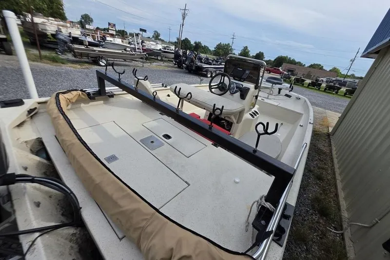 Slide: The Image of 2012 Xpress HD22CCF boat with fishing rod holders, steering console, and storage compartments. - 12