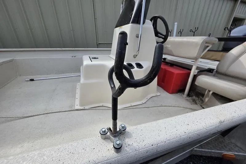 Slide: The Image of 2012 Xpress HD22CCF boat interior with steering wheel and rod holder. - 13
