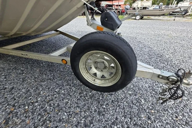 Slide: The Image of Trailer wheel of 2012 Xpress HD22CCF boat on gravel surface. - 15