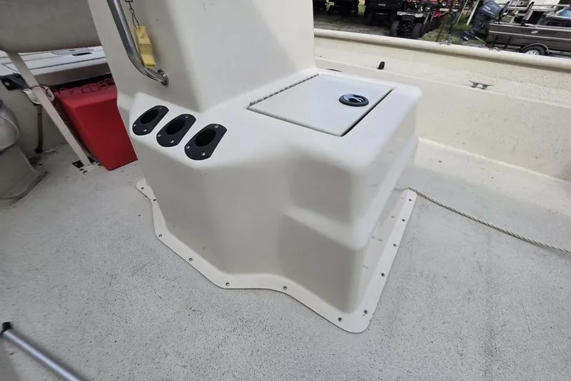 Slide: The Image of 2012 Xpress HD22CCF boat console with rod holders and storage compartment. - 5