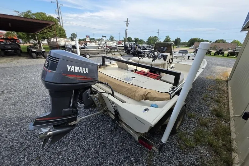 Slide: The Image of 2012 Xpress HD22CCF boat with Yamaha outboard motor in a gravel lot. - 7