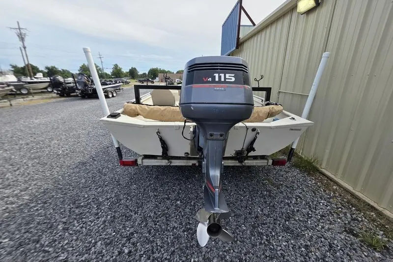 Slide: The Image of 2012 Xpress HD22CCF boat with V4 115 outboard motor, parked on gravel. - 8