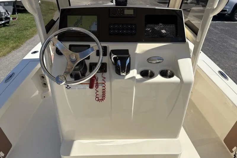 Slide: The Image of 2022 Scout 231 XSB boat console with steering wheel and controls. - 17