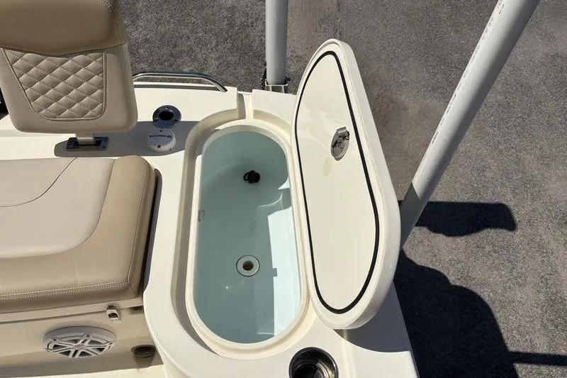 Slide: The Image of 2022 Scout 231 XSB boat with open livewell and cushioned seating. - 22