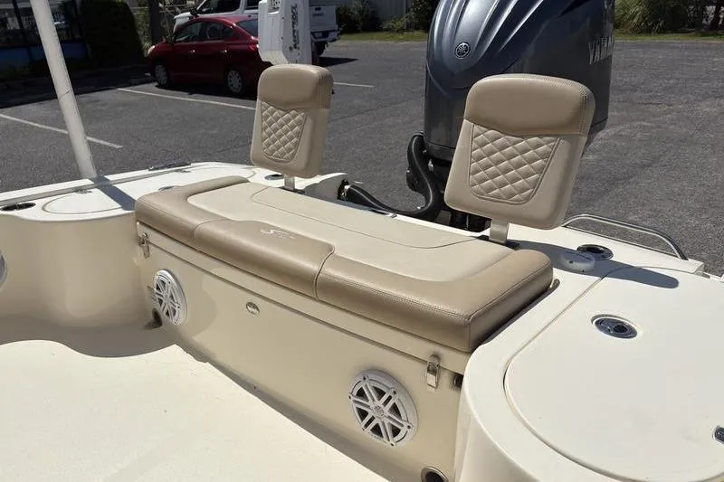 Slide: The Image of 2022 Scout 231 XSB boat interior with beige seating and Yamaha engine. - 23