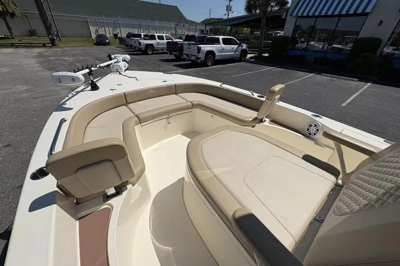 Slide: The Image of 2022 Scout 231 XSB boat with beige seating in a parking lot. - 8