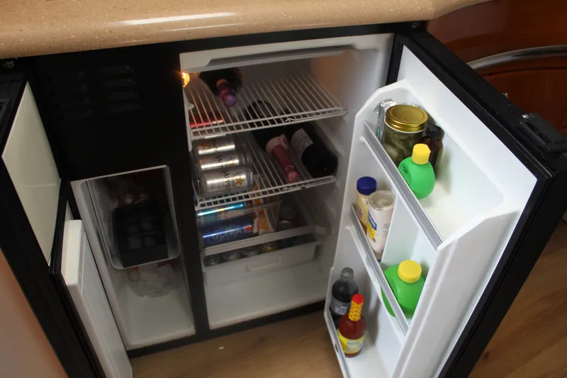 Slide: The Image of Open refrigerator in 2004 Formula 40 Performance Cruiser, stocked with beverages and condiments. - 26