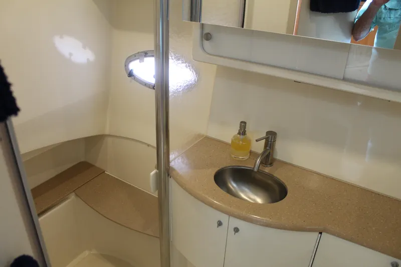 Slide: The Image of 2004 Formula 40 Performance Cruiser bathroom with sink, mirror, and porthole window. - 34