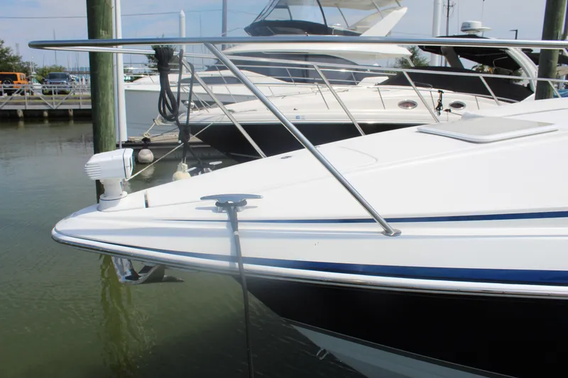 Slide: The Image of 2004 Formula 40 Performance Cruiser docked at marina, featuring sleek white hull design. - 4