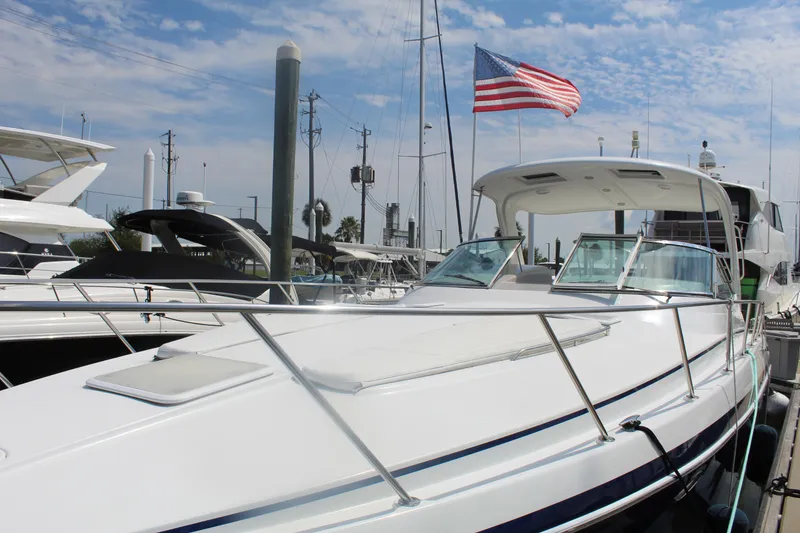 Slide: The Image of 2004 Formula 40 Performance Cruiser docked with American flag, clear sky background. - 6