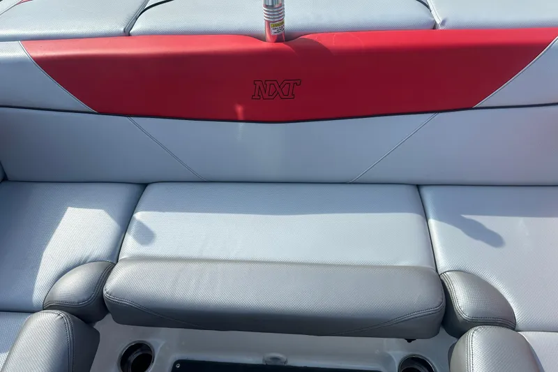 Slide: The Image of 2019 MasterCraft NXT20 boat interior with red and gray seating. - 11