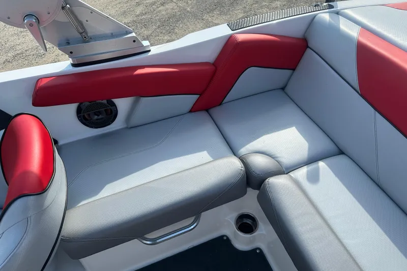 Slide: The Image of 2019 MasterCraft NXT20 boat interior with red and gray seating. - 12