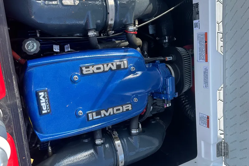 Slide: The Image of 2019 MasterCraft NXT20 engine featuring Ilmor 5000 MPI, blue cover, detailed view. - 13