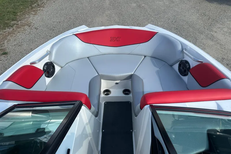 Slide: The Image of 2019 MasterCraft NXT20 boat interior with red and white seating and built-in speakers. - 15