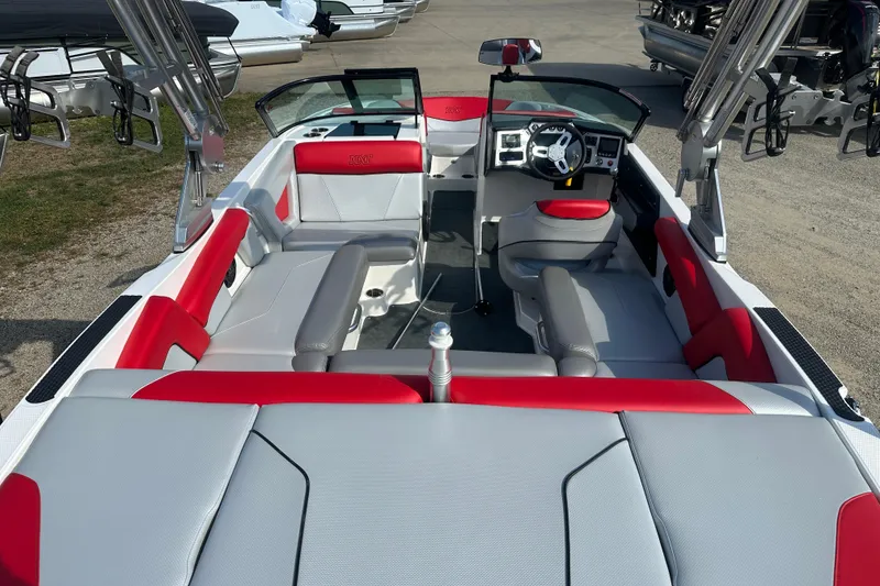 Slide: The Image of 2019 MasterCraft NXT20 boat interior with red and gray seating, steering wheel, and dashboard. - 4