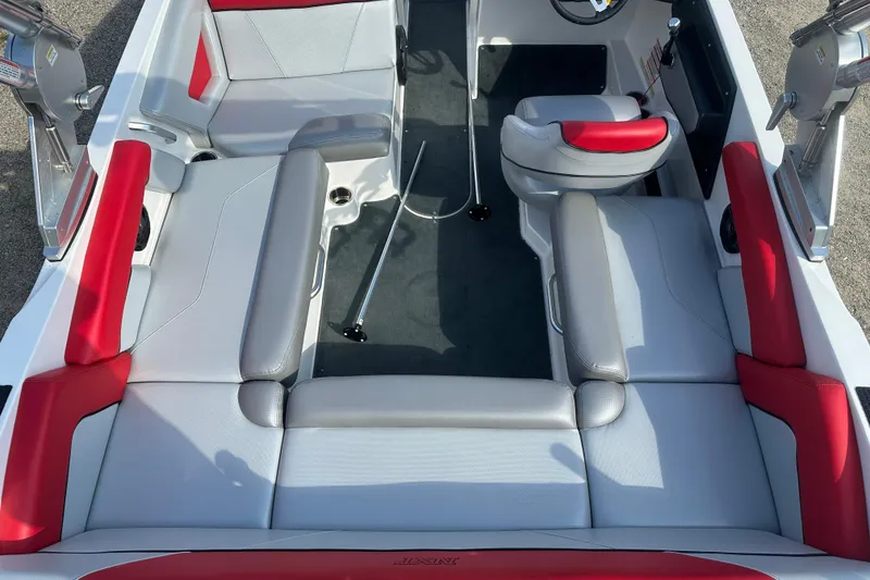 Slide: The Image of 2019 MasterCraft NXT20 boat interior with red and gray seating, steering wheel visible. - 5