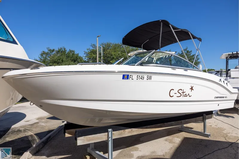 The Image of 2020 Chaparral 21 SSi OB boat on display with canopy and sleek design. - 0