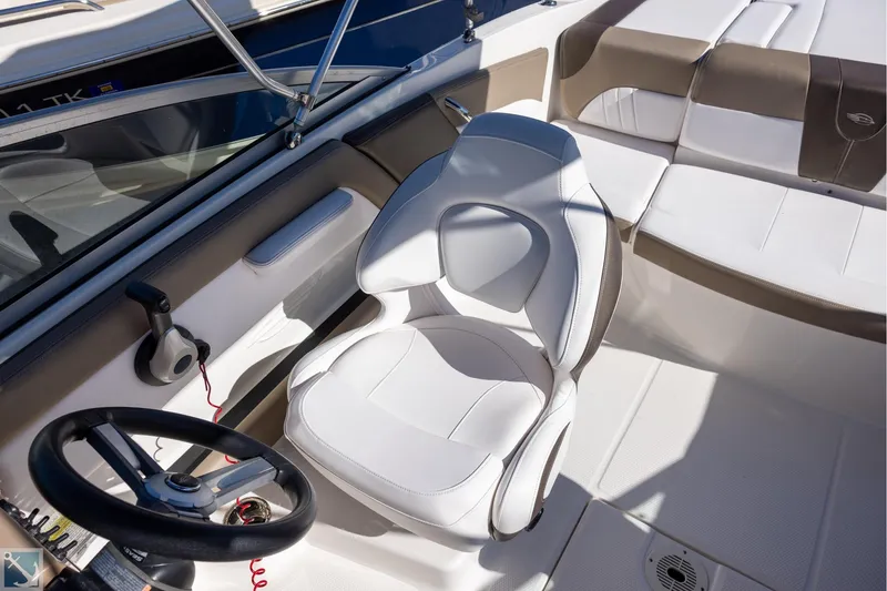 Slide: The Image of 2020 Chaparral 21 SSi OB boat interior with white and brown seating. - 8