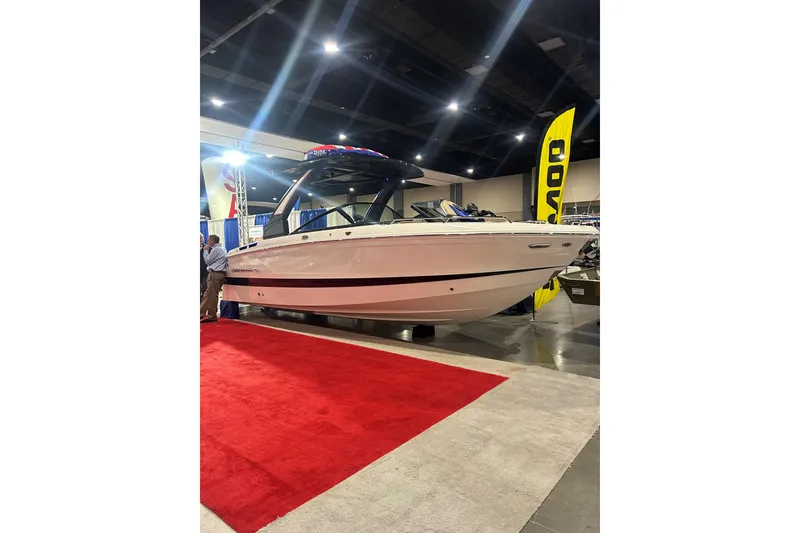 Slide: The Image of 2026 Chaparral SSX 6 boat displayed at an indoor exhibition on a red carpet. - 3