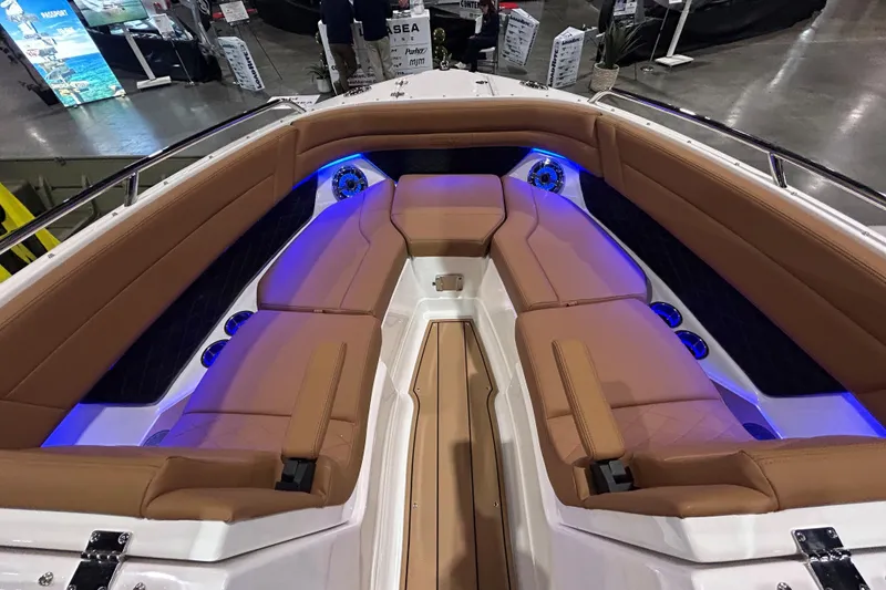 Slide: The Image of 2026 Chaparral SSX 6 boat interior with tan seating and blue LED lighting. - 4
