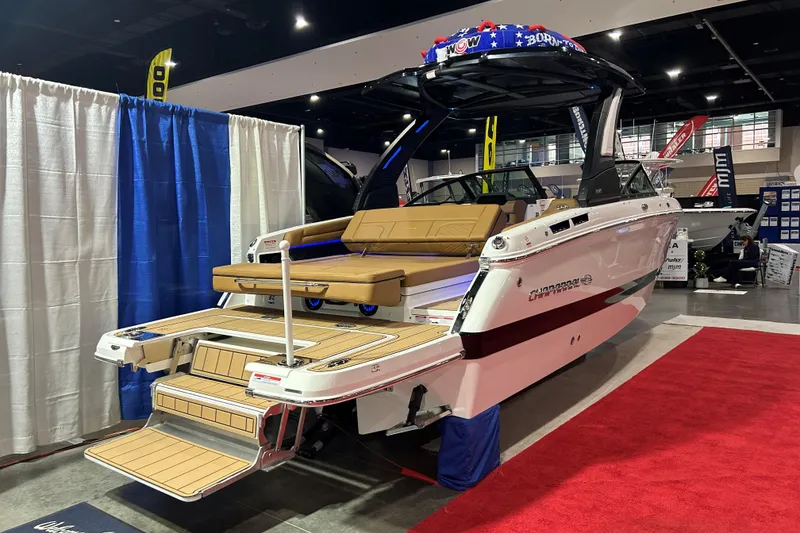 Slide: The Image of 2026 Chaparral SSX 6 boat displayed indoors with luxurious seating and swim platform. - 7