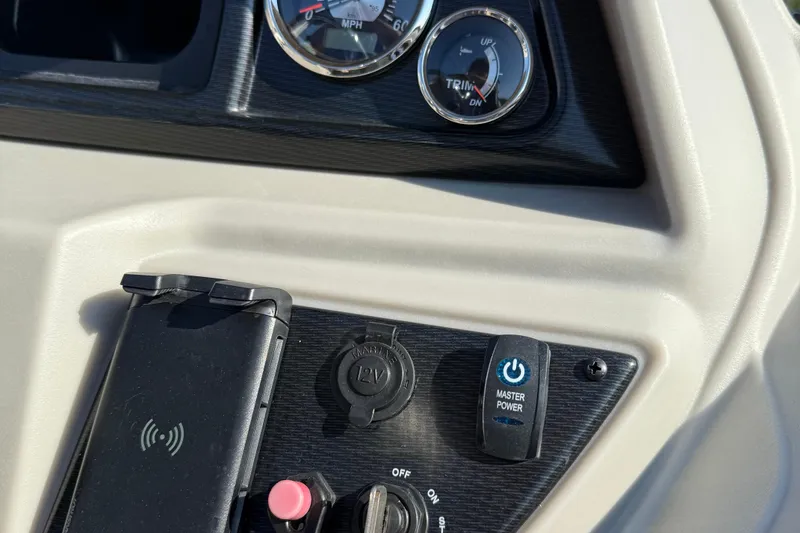 Slide: The Image of Dashboard controls of 2025 Berkshire 24CL 2.75 LE boat with power and trim gauges. - 13