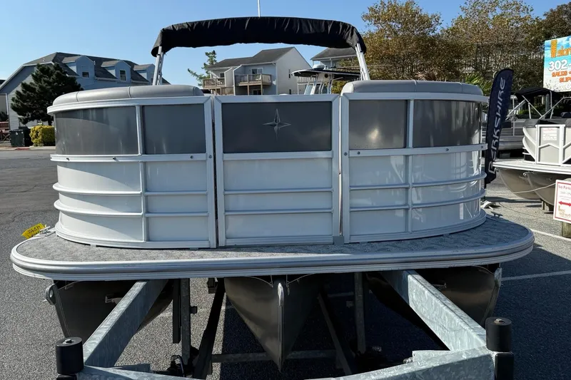 Slide: The Image of 2025 Berkshire 24CL 2.75 LE pontoon boat on trailer, outdoor display. - 3