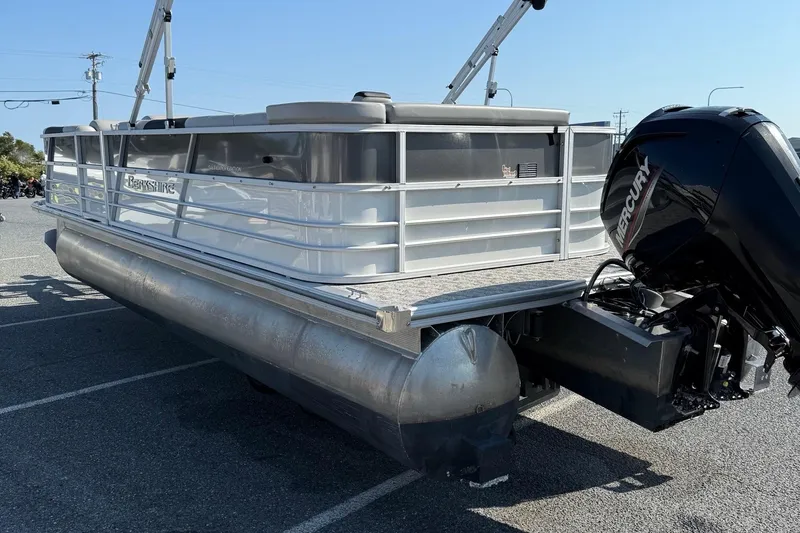Slide: The Image of 2025 Berkshire 24CL 2.75 LE pontoon boat with Mercury outboard engine in parking lot. - 6