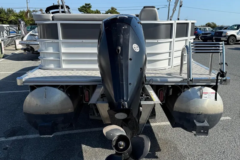 Slide: The Image of 2025 Berkshire 24CL 2.75 LE pontoon boat with outboard motor in parking lot. - 7