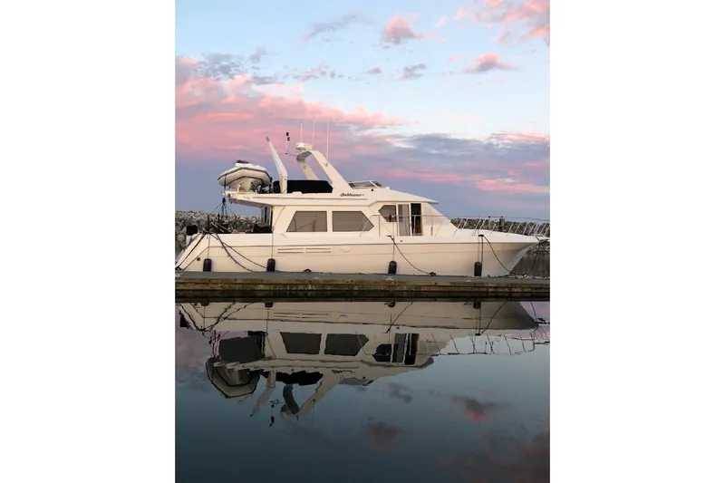 The Image of Navigator 53 yacht docked at sunset, reflecting on calm water, 2000 model. - 0