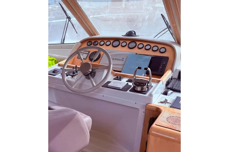 Slide: The Image of Navigator 53 yacht helm with steering wheel and navigation controls, year 2000 model. - 10